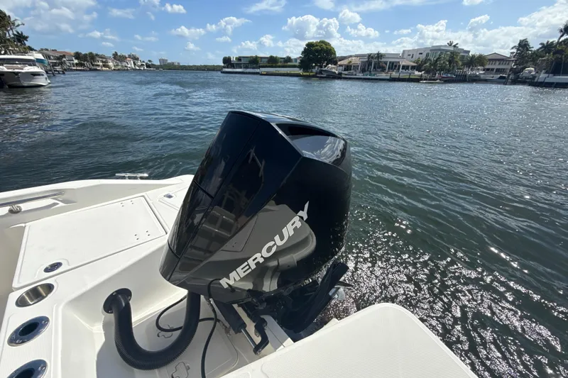 Slide: The Image of Boston Whaler 220 Dauntless 2023 with Mercury engine on a sunny waterfront. - 4