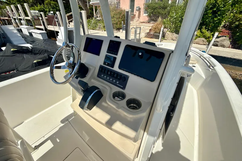 Slide: The Image of 2023 Boston Whaler 220 Dauntless boat console with steering wheel and controls. - 9