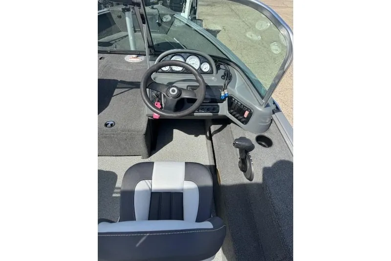 Slide: The Image of 2011 Lund 1875 Impact SS boat interior with steering wheel and dashboard controls. - 10