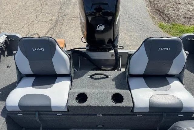 Slide: The Image of 2011 Lund 1875 Impact SS boat seats and motor, featuring dual cup holders. - 13