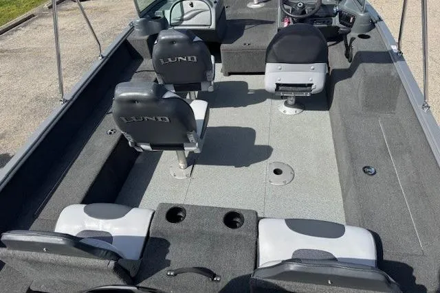 Slide: The Image of 2011 Lund 1875 Impact SS boat interior with seating and steering console. - 14