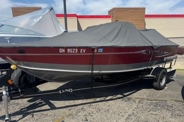 Slide: The Image of 2011 Lund 1875 Impact SS boat on trailer, covered, parked outdoors. - 24