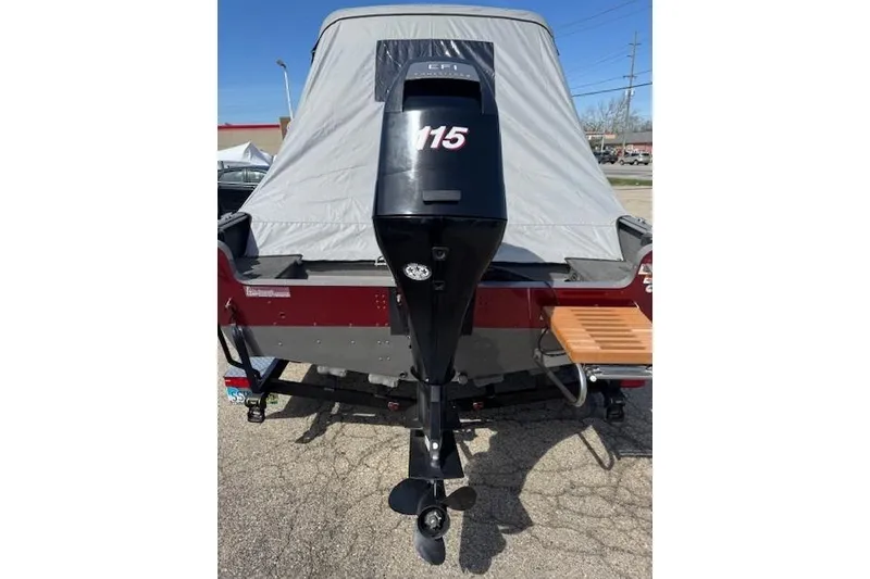 Slide: The Image of 2011 Lund 1875 Impact SS boat with 115 EFI outboard motor, covered and parked. - 5