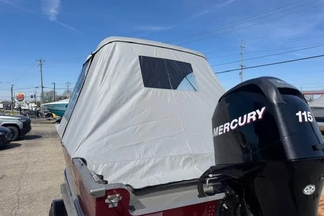 Slide: The Image of 2011 Lund 1875 Impact SS boat with Mercury 115 engine, covered and parked outdoors. - 6