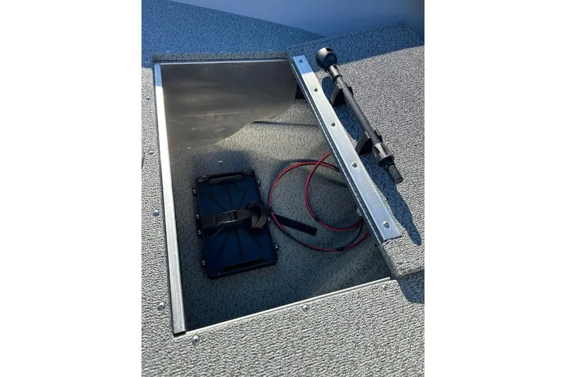 Slide: The Image of Open storage compartment in 2026 Smoker Craft Angler 16 SC boat, featuring wiring and equipment. - 14