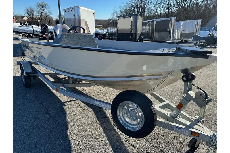 Slide: The Image of 2026 Smoker Craft Angler 16 SC boat on trailer, parked outdoors. - 17
