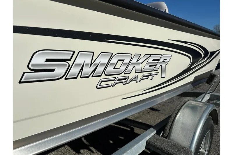 Slide: The Image of 2026 Smoker Craft Angler 16 SC boat logo on trailer, close-up view. - 2