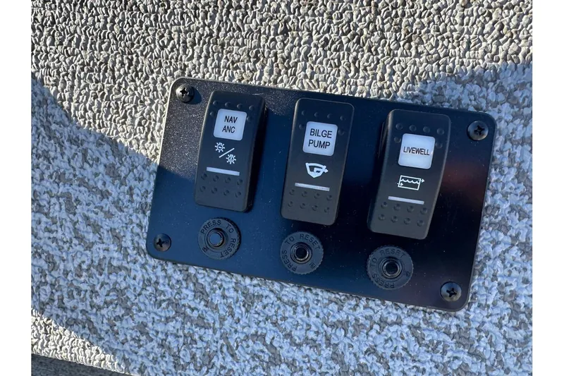 Slide: The Image of Control panel of 2026 Smoker Craft Angler 16 SC with switches for navigation, bilge pump, and livewell. - 9