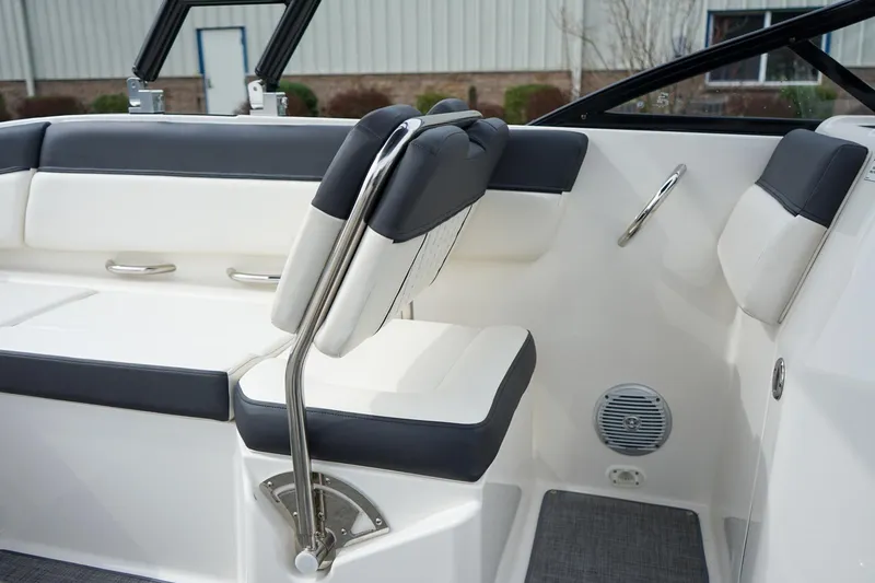 Slide: The Image of Interior seating of 2020 Bayliner DX 2200 boat, featuring sleek white and gray upholstery. - 13