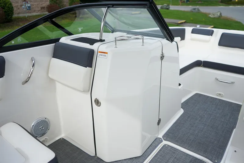 Slide: The Image of Interior view of 2020 Bayliner DX 2200 boat with seating and storage area. - 15