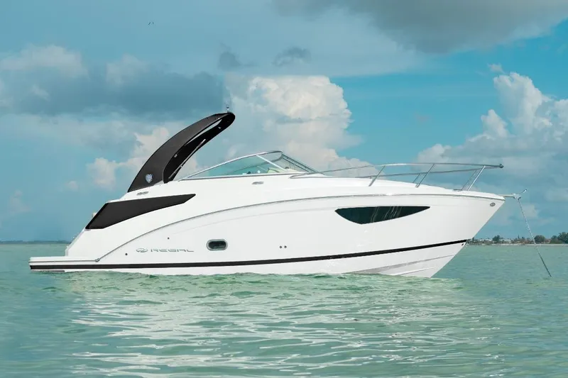 The Image of 2025 Regal 26 Express boat on calm water under a cloudy sky. - 0
