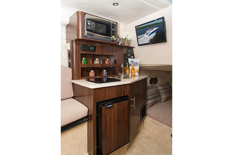 Slide: The Image of Manufacturer Provided Image: 2025 Regal 26 Express boat interior with kitchenette, microwave, and mini-fridge. - 12