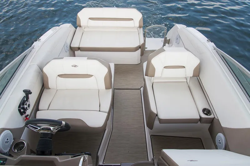 Slide: The Image of Manufacturer Provided Image: 2025 Regal 26 Express boat interior with white seating, steering wheel, and water backdrop. - 8