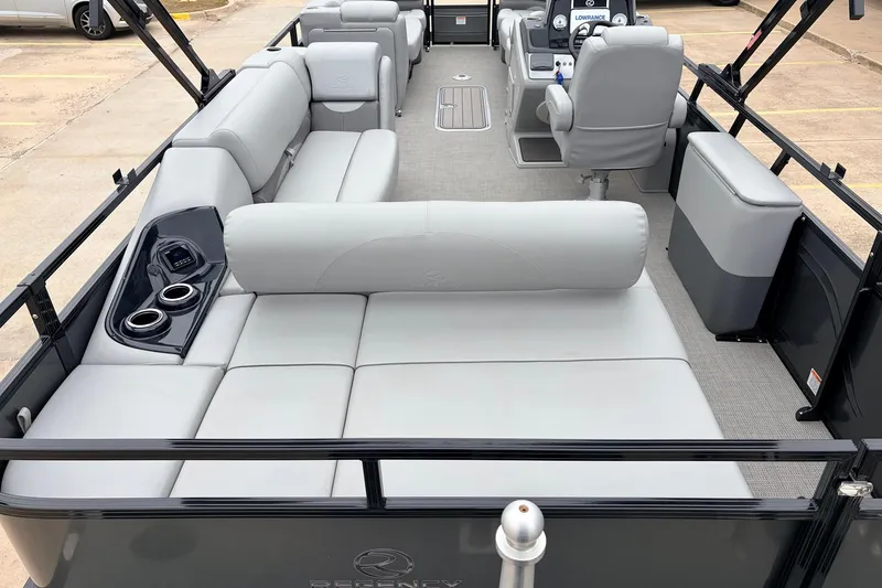 Slide: The Image of 2022 Regency 250 DL3 pontoon boat interior with plush seating and modern console. - 11