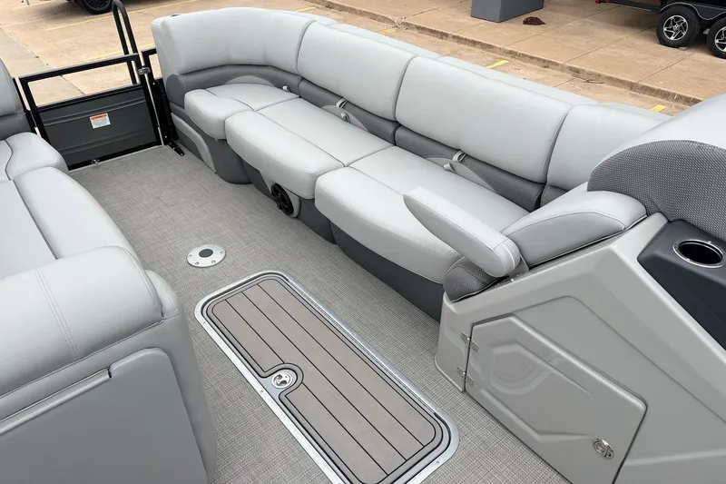 Slide: The Image of 2022 Regency 250 DL3 boat interior with plush gray seating and storage compartments. - 18