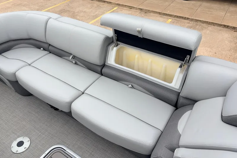Slide: The Image of 2022 Regency 250 DL3 boat with open storage compartment on gray cushioned seating. - 21