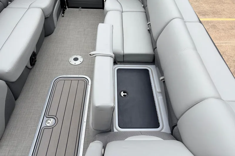 Slide: The Image of 2022 Regency 250 DL3 boat interior with gray seating and storage compartments. - 22