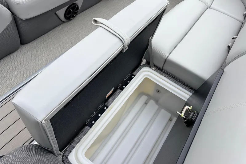 Slide: The Image of 2022 Regency 250 DL3 boat with open storage compartment and cushioned seating. - 23