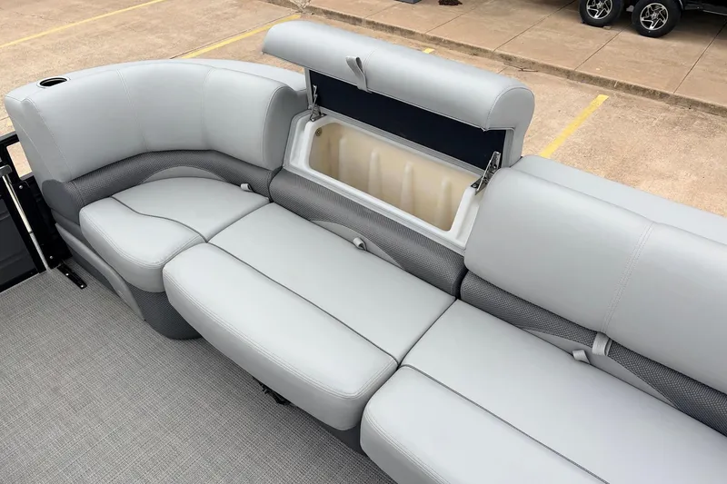 Slide: The Image of 2022 Regency 250 DL3 boat interior with open storage compartment and cushioned seating. - 24