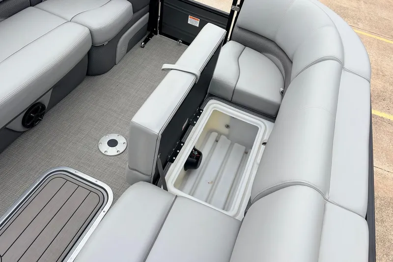 Slide: The Image of 2022 Regency 250 DL3 boat interior with open storage compartment and gray seating. - 25