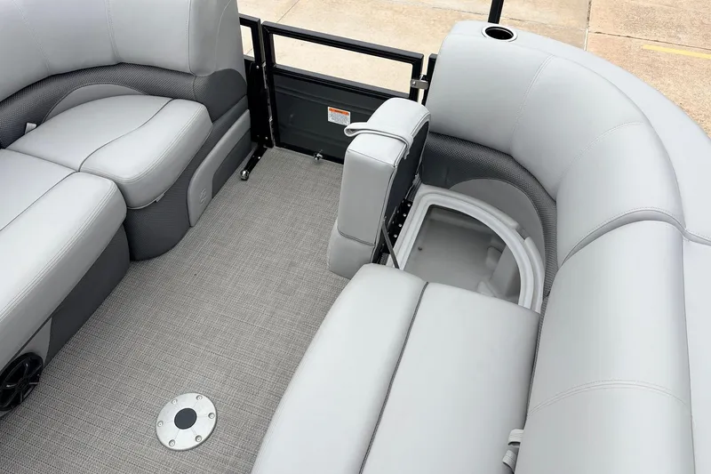 Slide: The Image of Interior of 2022 Regency 250 DL3 pontoon boat with gray seating and storage compartment. - 26