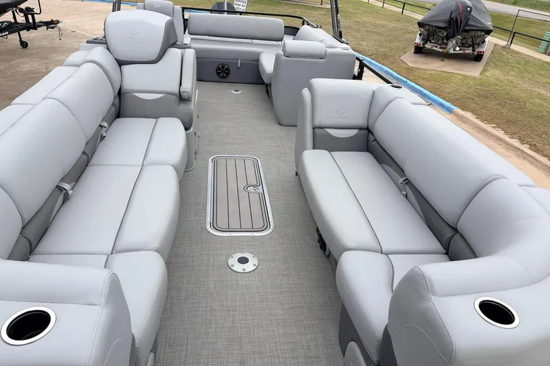 Slide: The Image of 2022 Regency 250 DL3 pontoon boat interior with plush gray seating and cup holders. - 27