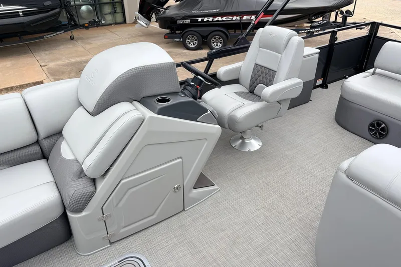 Slide: The Image of 2022 Regency 250 DL3 pontoon boat interior with plush seating and modern helm. - 30