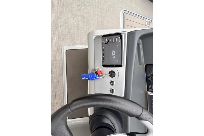 Slide: The Image of 2022 Regency 250 DL3 boat dashboard with steering wheel and control panel. - 36