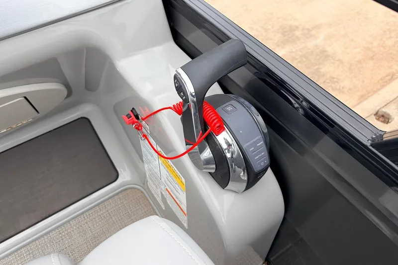 Slide: The Image of Throttle control of 2022 Regency 250 DL3 boat with safety lanyard and control panel. - 38