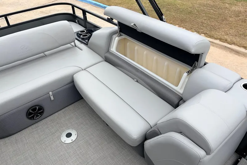 Slide: The Image of 2022 Regency 250 DL3 boat interior with gray seating and storage compartment open. - 40