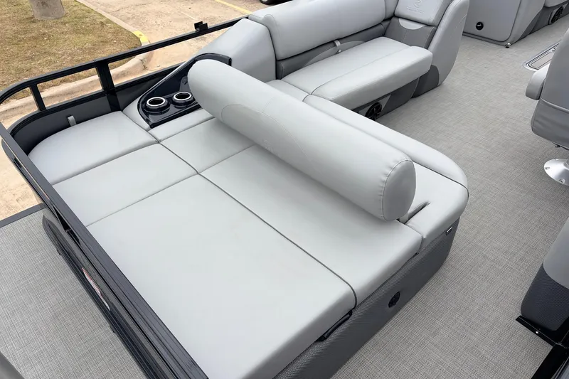 Slide: The Image of 2022 Regency 250 DL3 boat interior with gray cushioned seating and cup holders. - 45