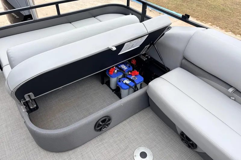 Slide: The Image of 2022 Regency 250 DL3 boat interior with open storage compartment revealing batteries. - 46