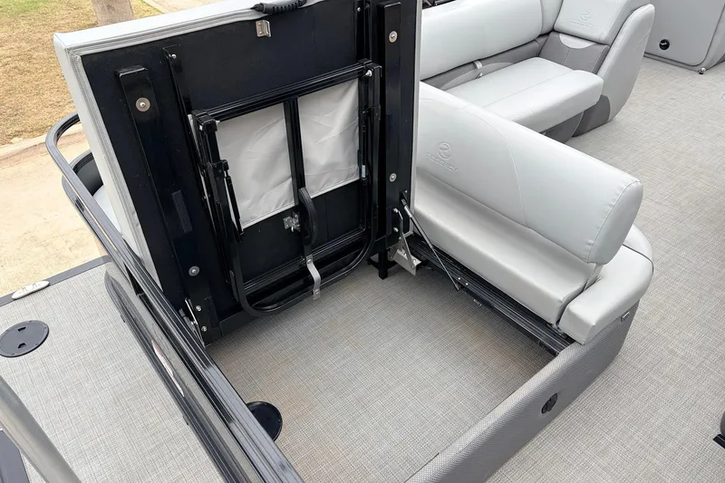 Slide: The Image of 2022 Regency 250 DL3 boat interior with foldable seating and storage compartment. - 49
