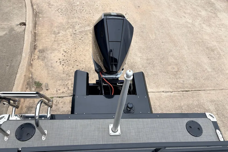 Slide: The Image of 2022 Regency 250 DL3 boat engine and deck, viewed from above on concrete surface. - 52