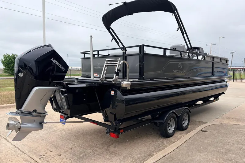 Slide: The Image of 2022 Regency 250 DL3 pontoon boat with Mercury outboard engine on trailer. - 6
