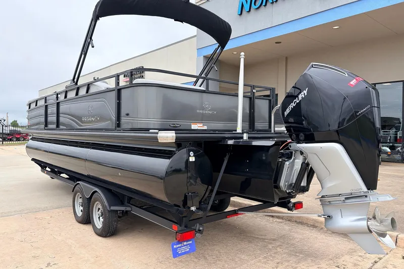 Slide: The Image of 2022 Regency 250 DL3 pontoon boat with Mercury outboard motor on trailer. - 9