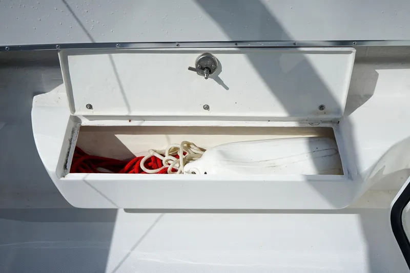 Slide: The Image of Storage compartment on 2024 C-Dory 23' Venture Sport boat with ropes inside. - 10