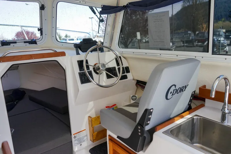 Slide: The Image of Interior of 2024 C-Dory 23' Venture Sport boat with steering wheel and sink. - 13