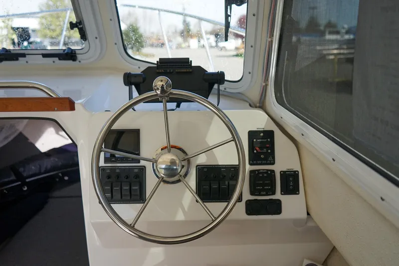 Slide: The Image of Helm of 2024 C-Dory 23' Venture Sport boat with steering wheel and control panel. - 14