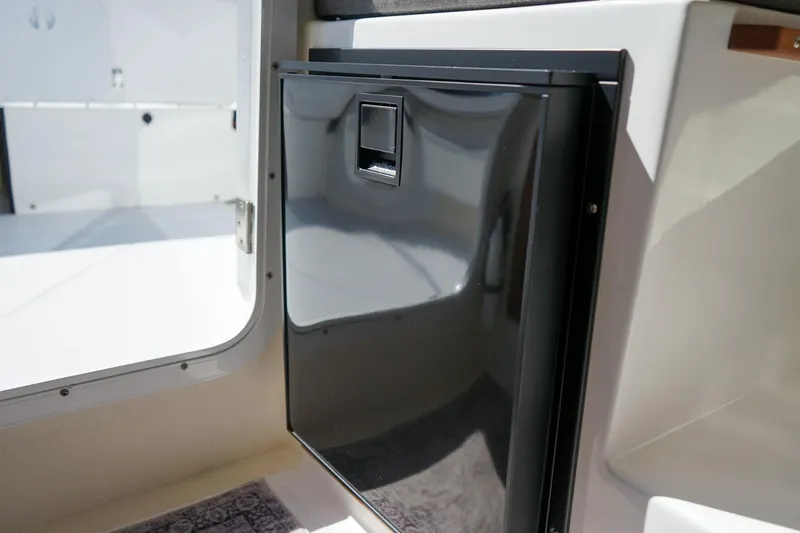 Slide: The Image of 2024 C-Dory 23' Venture Sport interior with sleek black cabinet. - 17