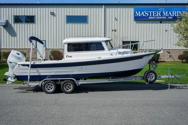 Slide: The Image of 2024 C-Dory 23' Venture Sport boat on trailer outside Master Marine Boat Center. - 3
