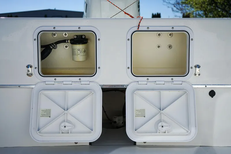 Slide: The Image of Open storage compartments on a 2024 C-Dory 23' Venture Sport boat. - 8