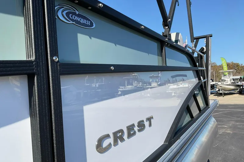 Slide: The Image of 2026 Crest Conquest 230 SLSC boat side view with logo and sleek design. - 10