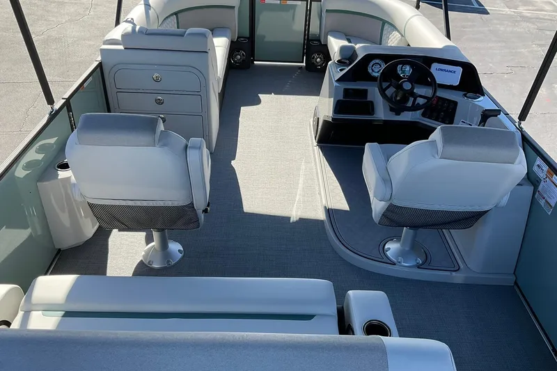 Slide: The Image of 2026 Crest Conquest 230 SLSC boat interior with helm, seating, and storage compartments. - 20