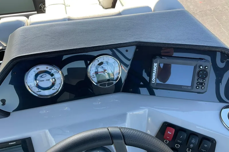 Slide: The Image of Dashboard of 2026 Crest Conquest 230 SLSC boat with gauges and Lowrance display. - 23