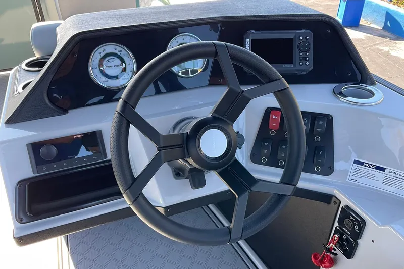 Slide: The Image of Steering console of 2026 Crest Conquest 230 SLSC boat with gauges and controls. - 24