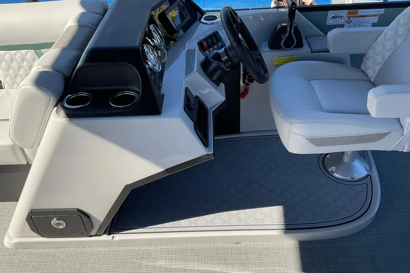 Slide: The Image of Helm of 2026 Crest Conquest 230 SLSC boat with modern controls and seating. - 25