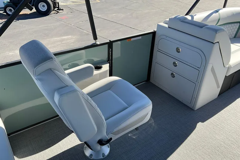 Slide: The Image of 2026 Crest Conquest 230 SLSC boat interior with seating and storage compartments. - 26