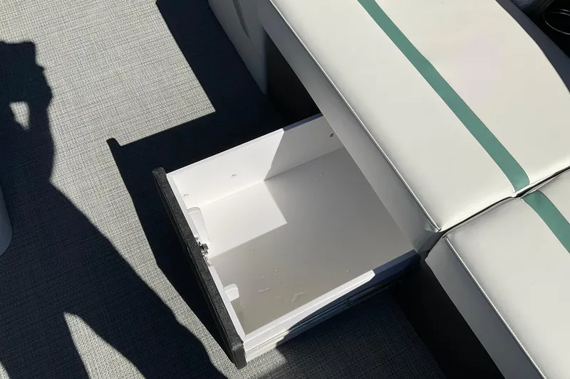 Slide: The Image of Open storage compartment in 2026 Crest Conquest 230 SLSC boat, featuring sleek seating design. - 33