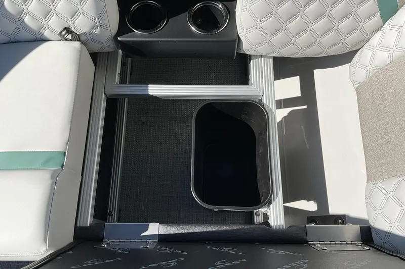 Slide: The Image of Interior of 2026 Crest Conquest 230 SLSC boat with cup holders and storage compartment. - 34